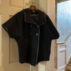 Black wool jacket with cropped sleeves and vegan leather trim.